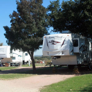 Shaded RV sites available at Peach Country RV Park near Fredericksburg, TX.